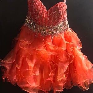 Short, coral color prom dress.   Size 14 lace up